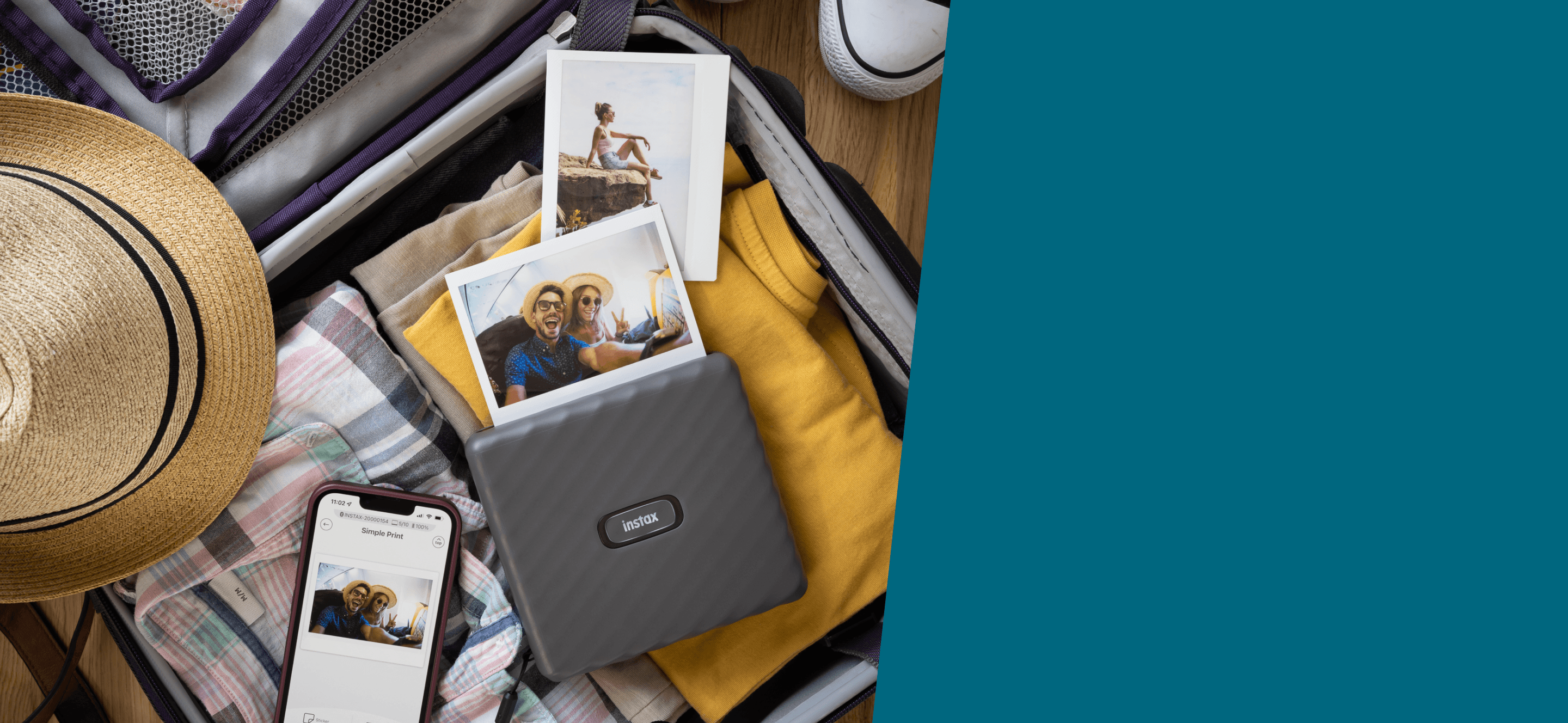 Фотопринтер Fujifilm Instax Link Wide White среди вещей в чемодане рядом с напечатанными снимками путешествия